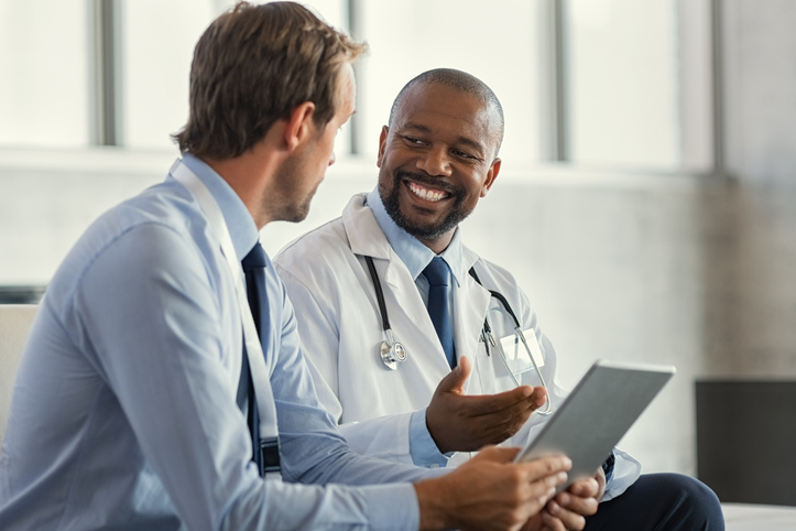 Healthcare workers using a tablet that is managed and secured by SOTI MobiControl