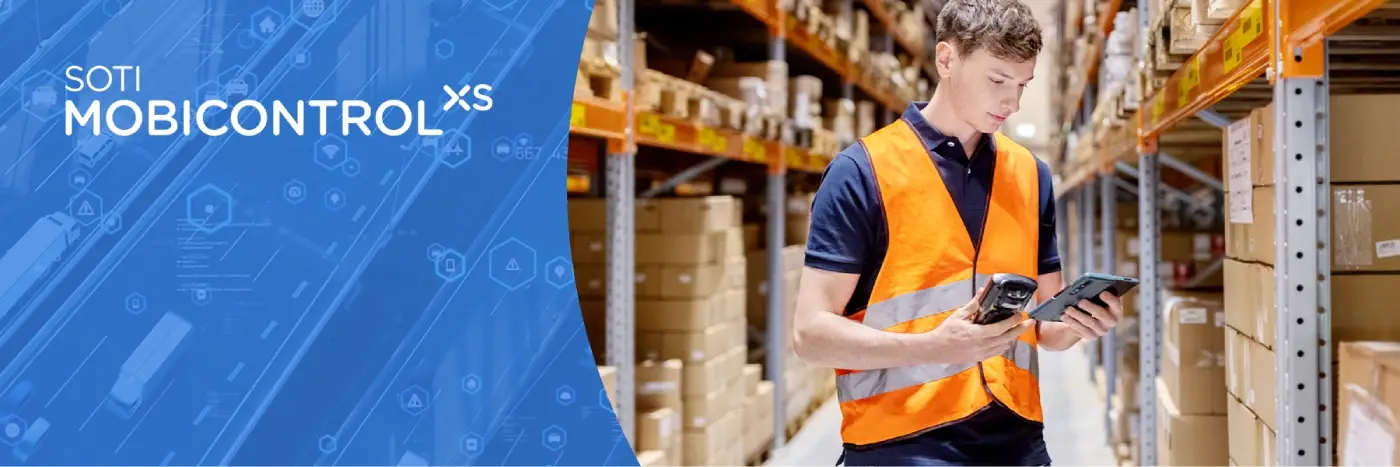 Man staring at devices in a warehouse. SOTI Mobicontrol XS